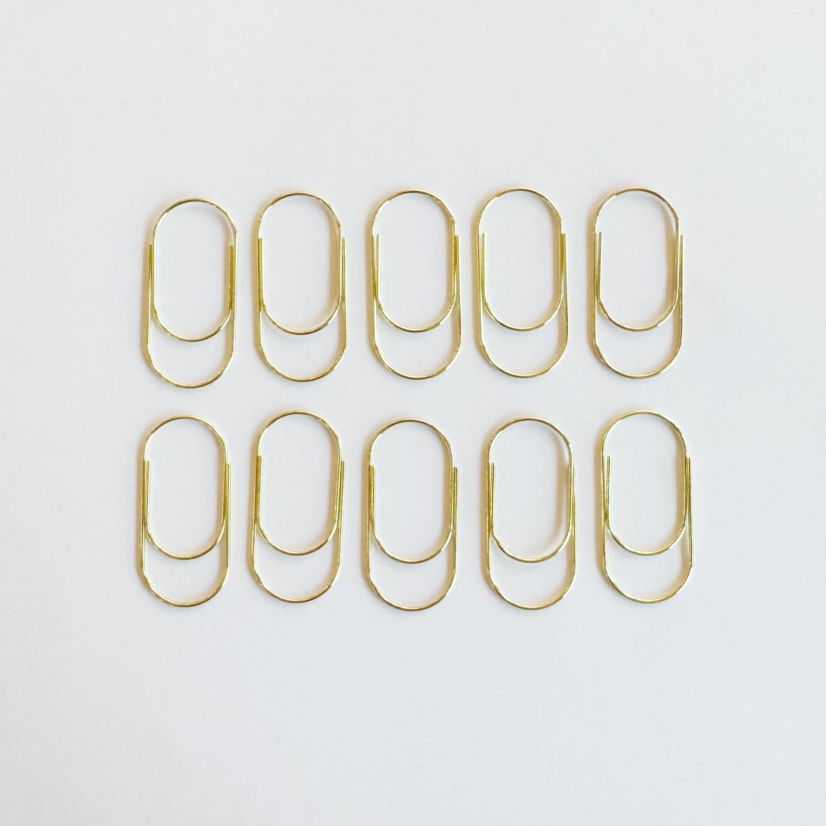 Big metal paper clip in gold finish