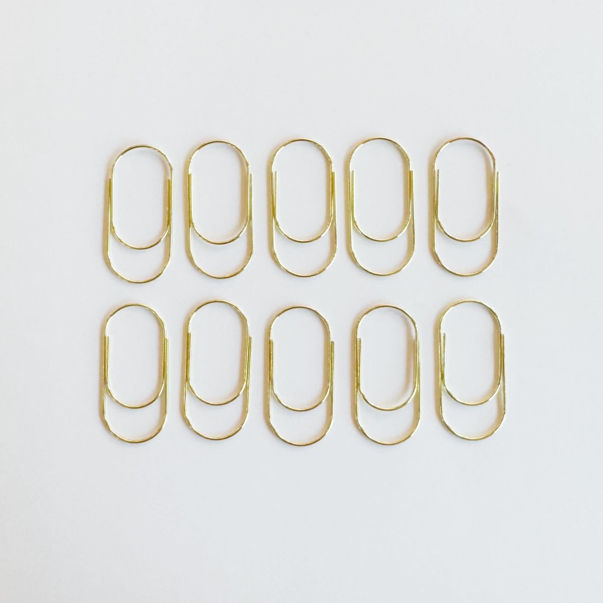 Big metal paper clip in gold finish