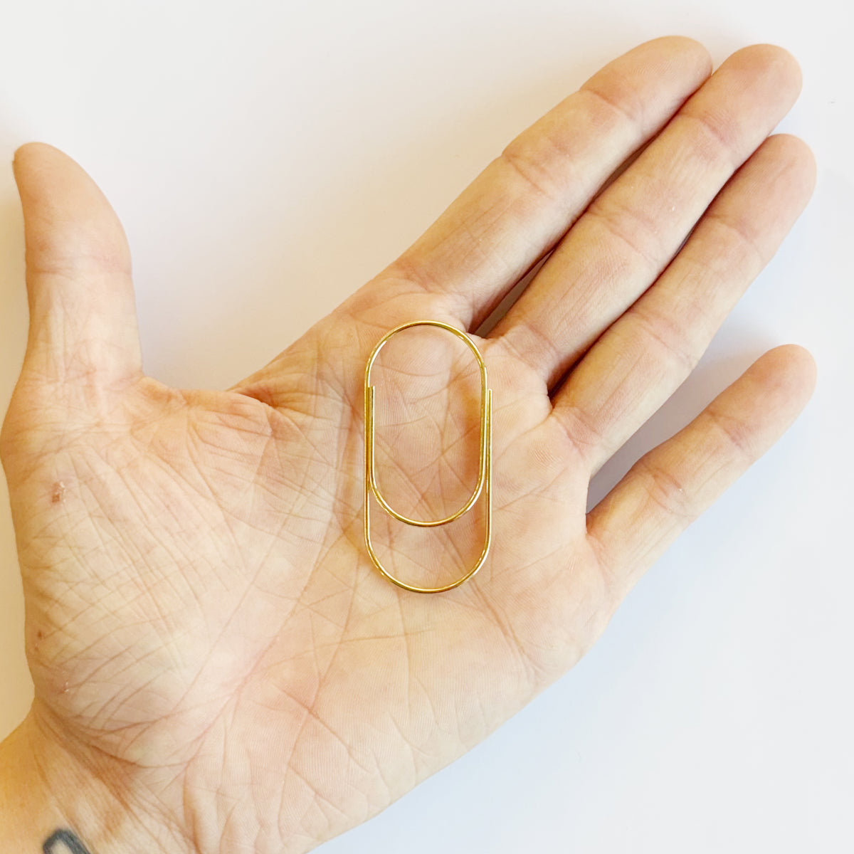 Big metal paper clip in use on a frame