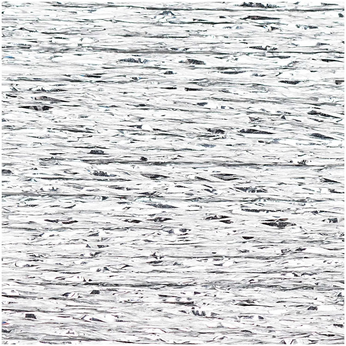 Close-up of shimmering silver metallic embroidery thread texture