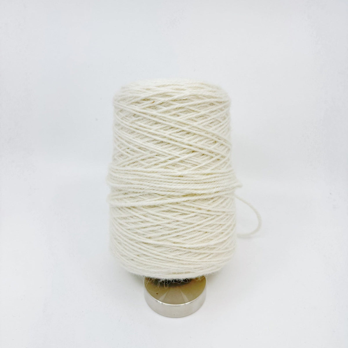 Tufting wool cone with yarn end detail