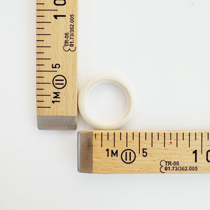 Wooden ring held in hand for scale